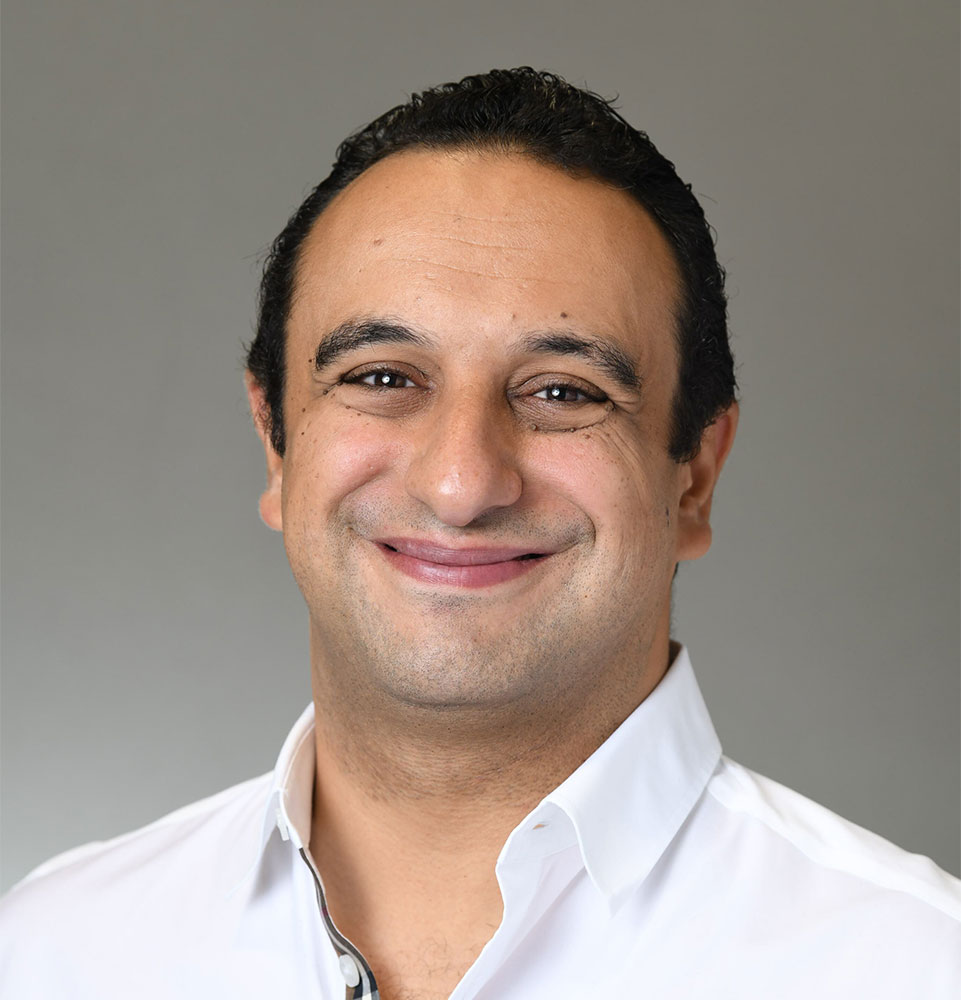 headshot of doctor smiling brightly